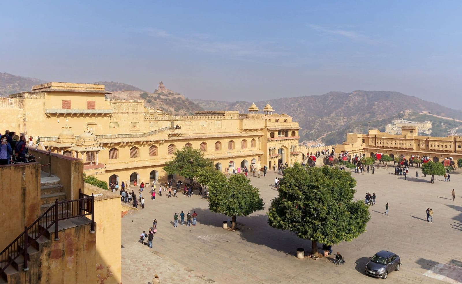 The wide Jaleb Chowk courtyard of Amber Fort, with the Aravalli hills behind